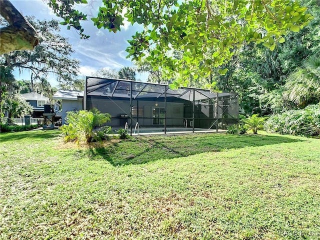 view of yard with glass enclosure