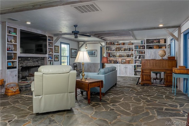 4210 W Horseshoe Dr, Beverly Hills, FL 34465 - living room featuring stone floors, a ceiling fan, a fireplace, recessed lighting, and built in shelves