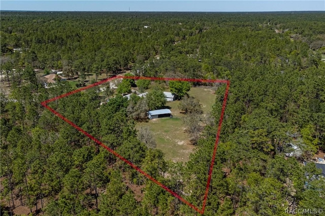 birds eye view of property with a forest view