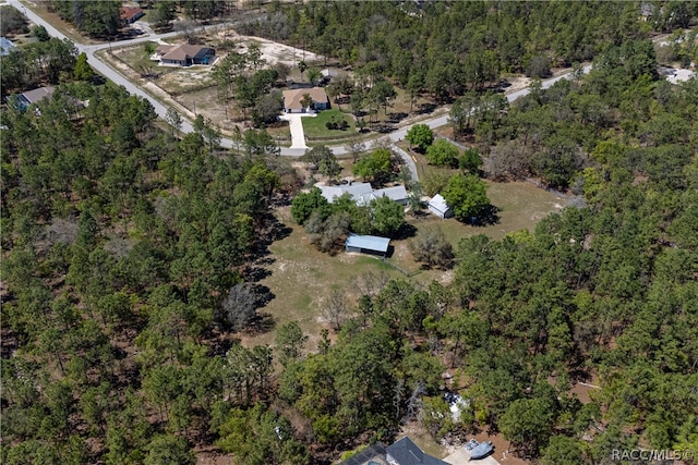 birds eye view of property featuring a wooded view