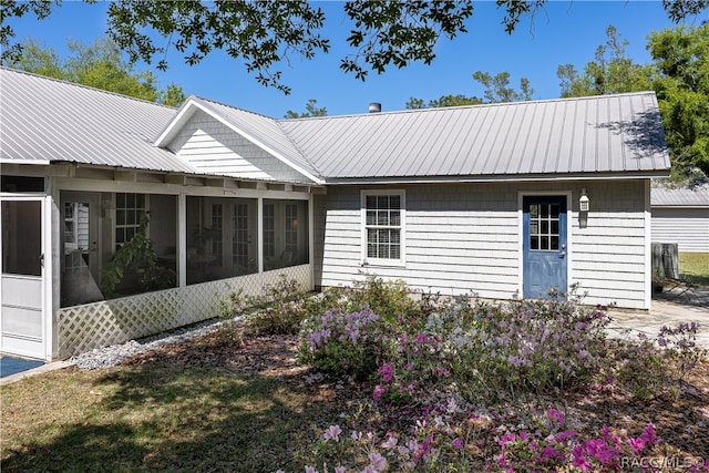 view of front of property with a sunroom and metal roof