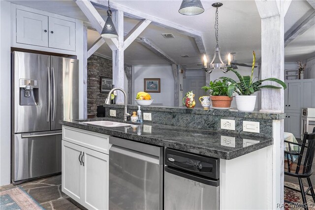 4210 W Horseshoe Dr, Beverly Hills, FL 34465 - kitchen featuring stainless steel appliances, white cabinetry, a kitchen island with sink, pendant lighting, and a chandelier