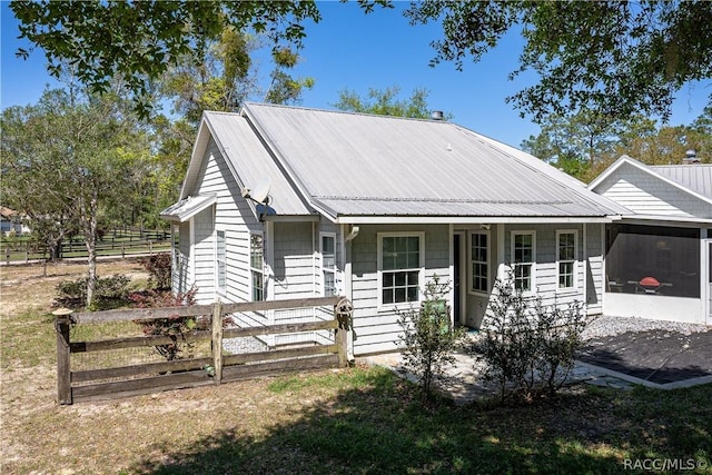 view of front of home with fence and metal roof