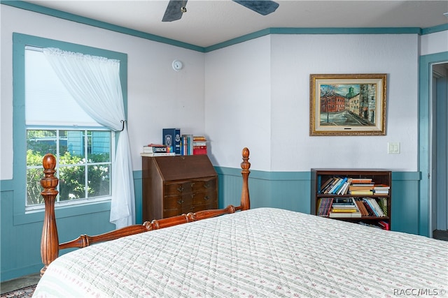 bedroom with wainscoting and a ceiling fan