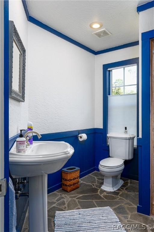 4210 W Horseshoe Dr, Beverly Hills, FL 34465 - half bath featuring stone flooring and wainscoting