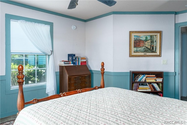 bedroom featuring wainscoting and a ceiling fan