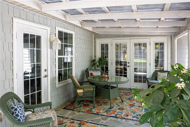 sunroom / solarium featuring french doors and beamed ceiling