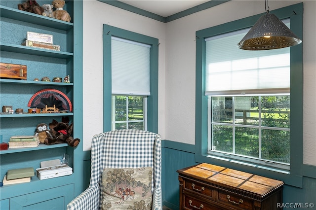 sitting room featuring a wainscoted wall and built in features