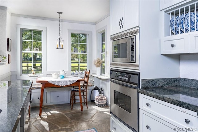 4210 W Horseshoe Dr, Beverly Hills, FL 34465 - kitchen with appliances with stainless steel finishes, healthy amount of natural light, white cabinetry, stone finish floors, and crown molding