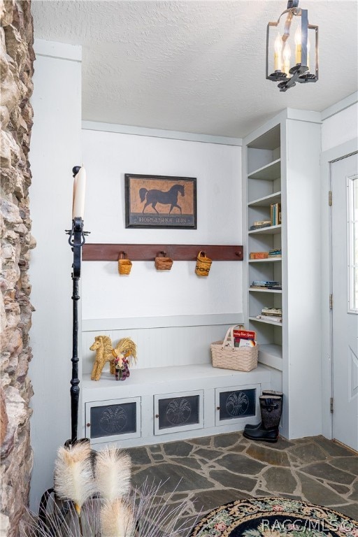 room details with a textured ceiling and an inviting chandelier