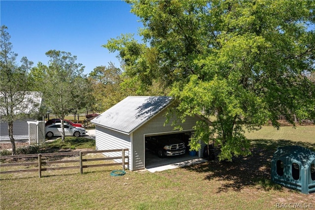 view of outbuilding with fence and an outbuilding