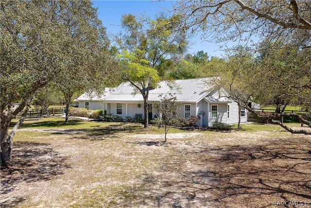 ranch-style home featuring metal roof