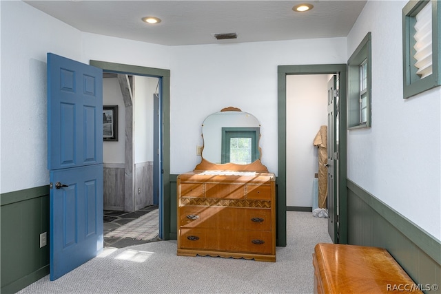 hallway with recessed lighting, carpet, visible vents, and wainscoting