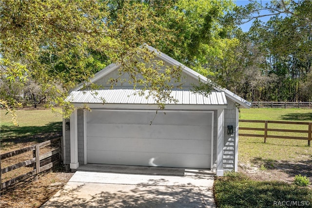 detached garage featuring fence