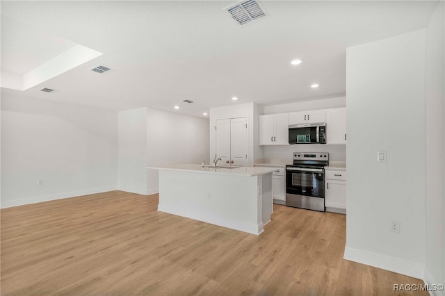 784 E Alaska Ln, Hernando, FL 34442 - kitchen featuring appliances with stainless steel finishes, white cabinets, light countertops, recessed lighting, and light wood-type flooring