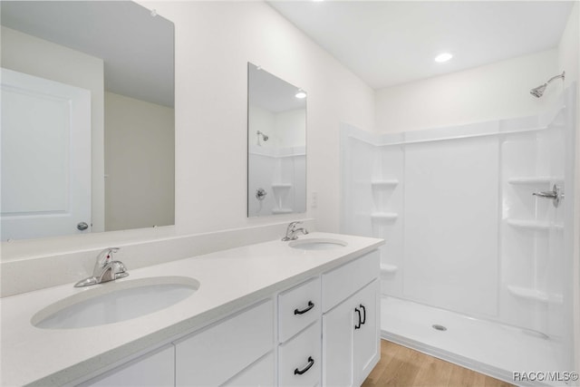 784 E Alaska Ln, Hernando, FL 34442 - bathroom featuring double vanity, wood finished floors, and a shower