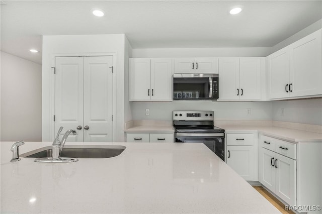 784 E Alaska Ln, Hernando, FL 34442 - kitchen featuring stainless steel appliances, white cabinetry, recessed lighting, and light stone countertops