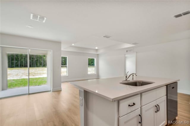 784 E Alaska Ln, Hernando, FL 34442 - kitchen with open floor plan, light wood finished floors, stainless steel dishwasher, white cabinetry, and light countertops