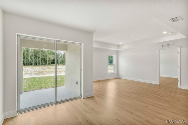 784 E Alaska Ln, Hernando, FL 34442 - empty room featuring light wood-style flooring, a raised ceiling, and recessed lighting