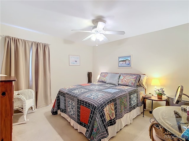 bedroom with ceiling fan and light carpet