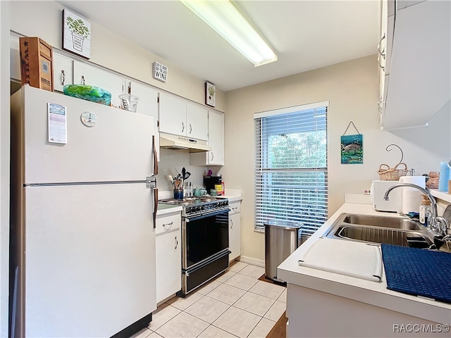 kitchen with black range, white refrigerator, sink, light tile patterned flooring, and white cabinetry