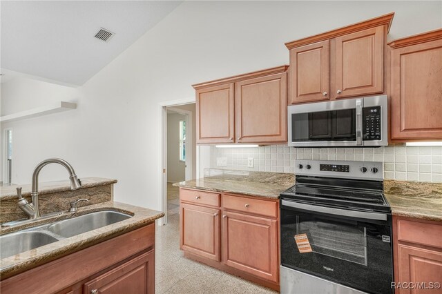 1324 Circus Ter, Hernando, FL 34442 - kitchen featuring a sink, stainless steel appliances, lofted ceiling, tasteful backsplash, and visible vents
