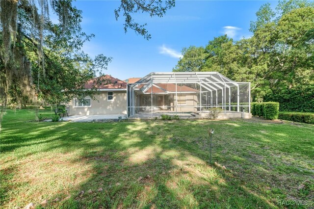 1324 Circus Ter, Hernando, FL 34442 - back of house featuring a lawn and a patio area