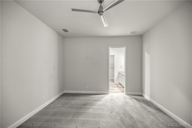 spare room featuring carpet flooring and ceiling fan