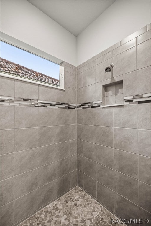 bathroom with tiled shower