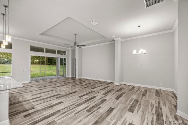 unfurnished living room with crown molding, light hardwood / wood-style floors, and ceiling fan with notable chandelier