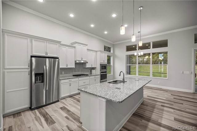 kitchen with white cabinetry, sink, light stone counters, and appliances with stainless steel finishes