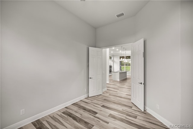 spare room featuring light hardwood / wood-style flooring