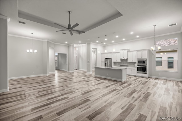 unfurnished living room with crown molding, light hardwood / wood-style floors, and ceiling fan with notable chandelier