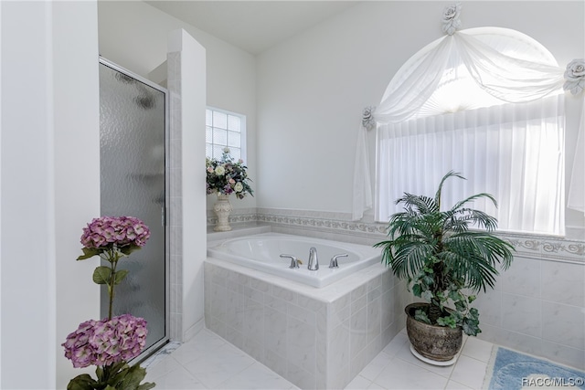 bathroom with tile patterned floors and a shower with door