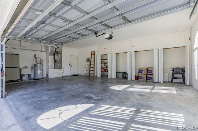 garage with heating unit, water heater, sink, and a garage door opener