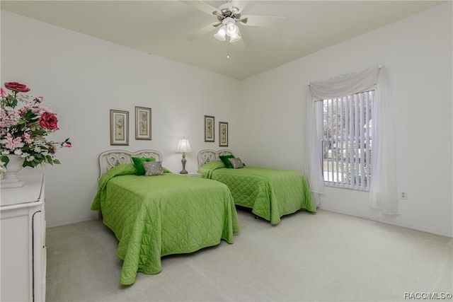 bedroom with ceiling fan and light carpet