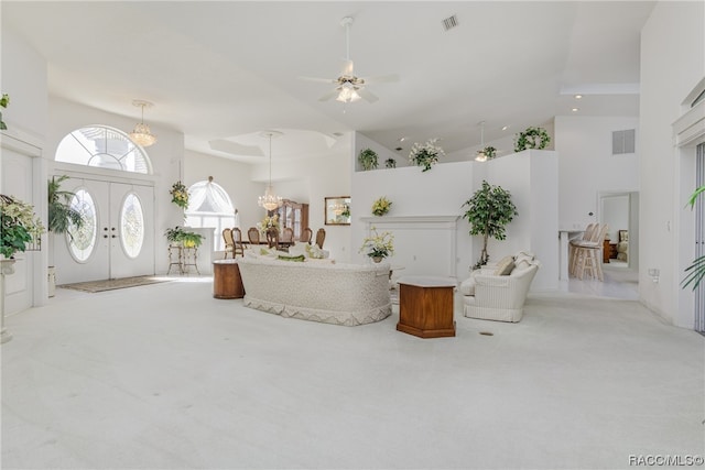 interior space with ceiling fan with notable chandelier, high vaulted ceiling, and french doors