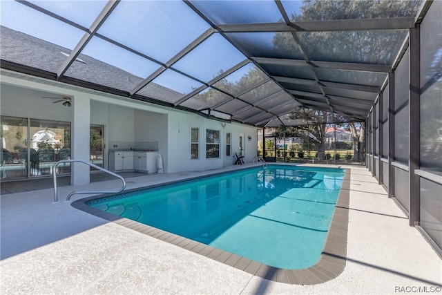 view of swimming pool with a patio, ceiling fan, and a lanai