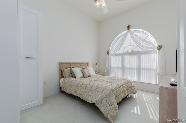 carpeted bedroom with ceiling fan and lofted ceiling