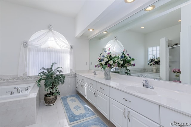 bathroom with plus walk in shower, tile patterned flooring, and vanity