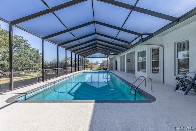 view of swimming pool with a lanai and a patio