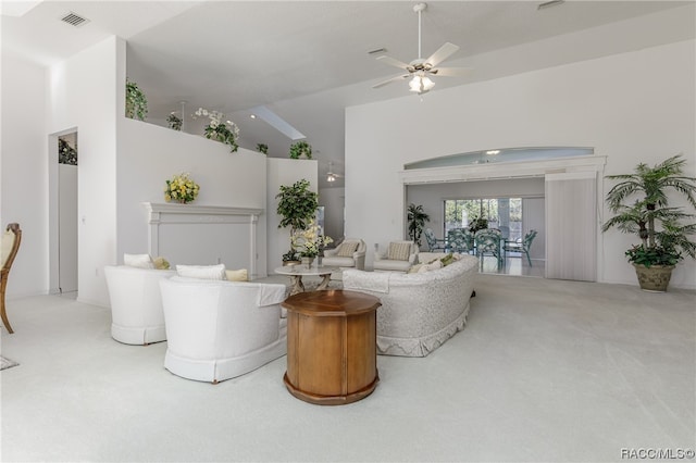 living room featuring ceiling fan, carpet floors, and high vaulted ceiling