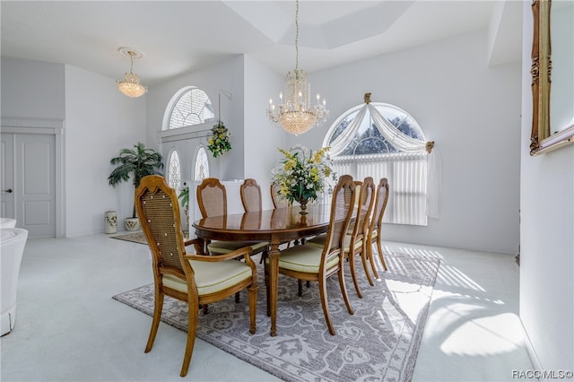 dining area with french doors, light colored carpet, and a notable chandelier