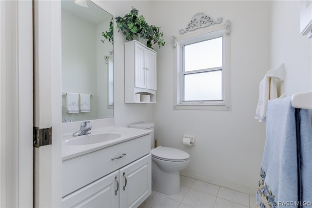 bathroom with tile patterned flooring, vanity, and toilet