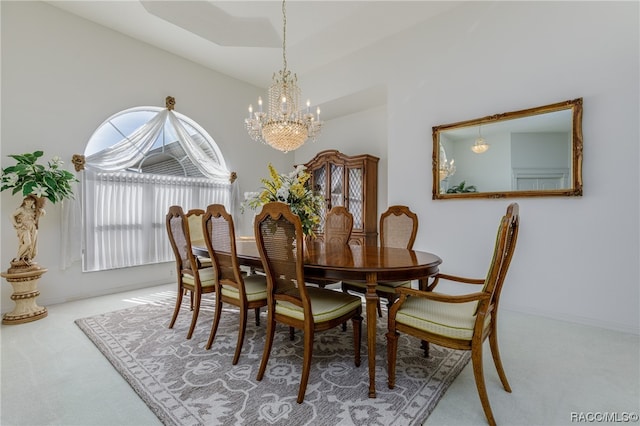 dining area with carpet floors and a chandelier