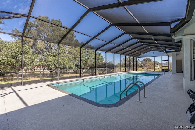 view of swimming pool with a lanai and a patio area