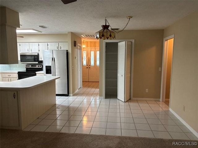 3365 S Crossbill Loop, Inverness, FL 34450 - kitchen with appliances with stainless steel finishes, light countertops, white cabinetry, light tile patterned flooring, and french doors