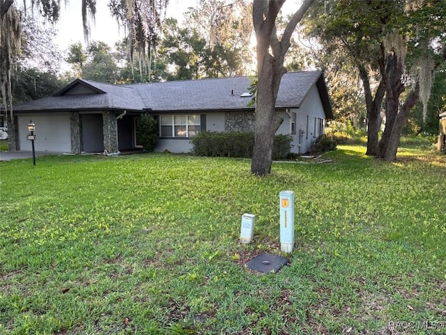 3365 S Crossbill Loop, Inverness, FL 34450 - single story home with an attached garage, a front lawn, stone siding, and a shingled roof