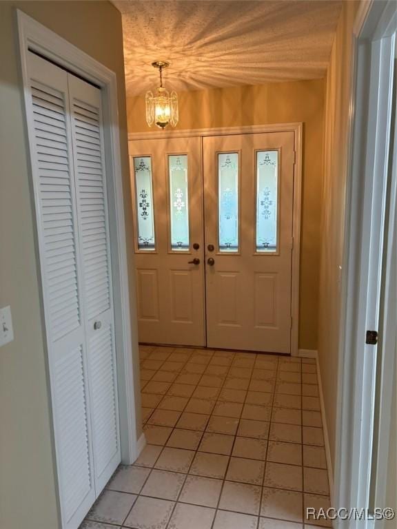 3365 S Crossbill Loop, Inverness, FL 34450 - foyer with light tile patterned floors and a chandelier