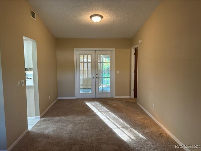 3365 S Crossbill Loop, Inverness, FL 34450 - carpeted empty room featuring french doors and a textured ceiling